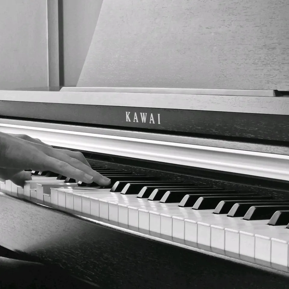 My hand playing the keys of a piano